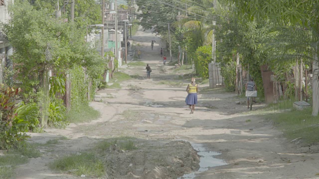 古巴哈瓦那的一条土路上，行人和骑自行车的人在行走视频素材