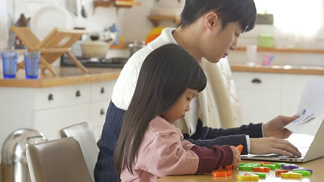 一个韩国爸爸和一个女儿坐在桌子上视频素材画面4