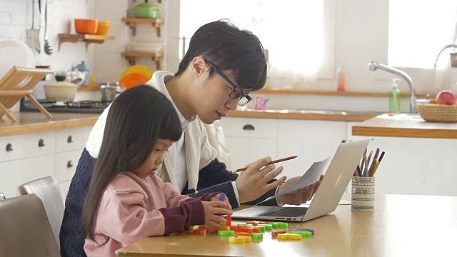 一个韩国爸爸和一个女儿坐在桌子上视频素材画面3