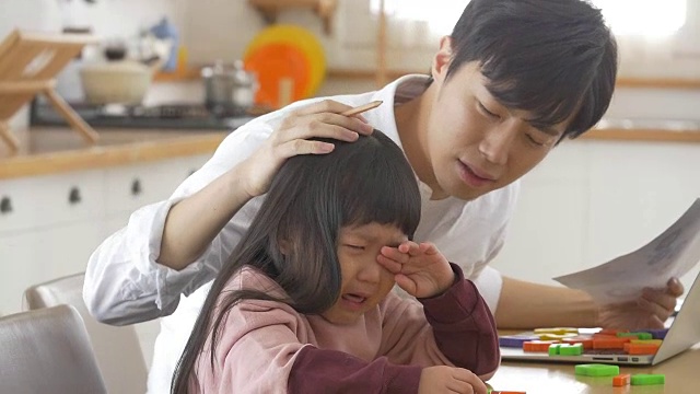 一位韩国父亲在看着哭泣的女儿视频素材画面1